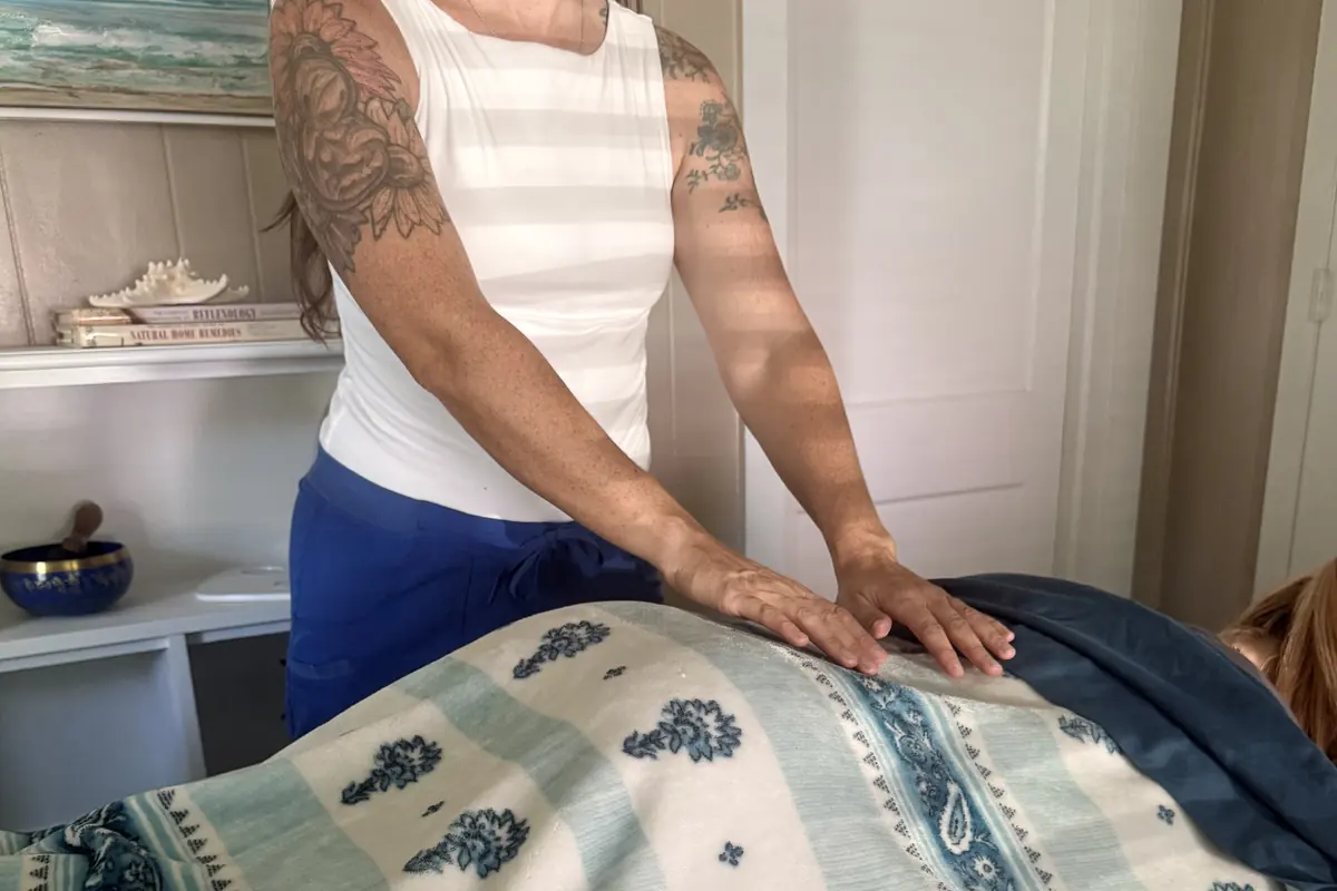 Sharee Seres, Florida Licensed Massage Therapist, working on a fully draped client during an in-home massage session